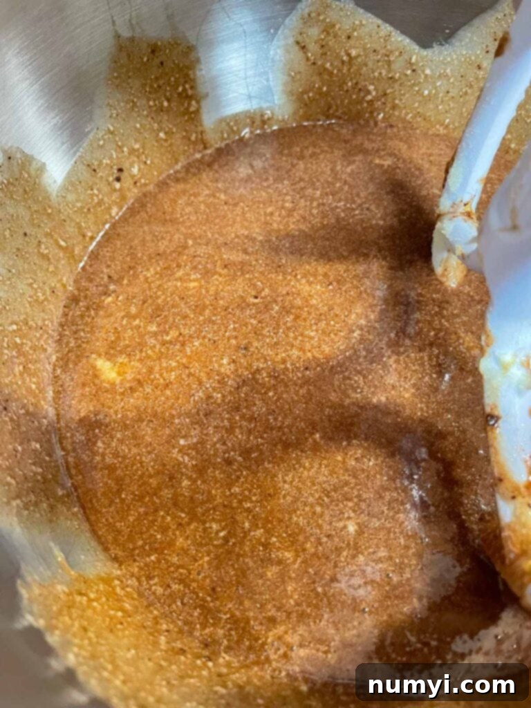 Smooth, light, and fluffy cake batter in a large metal mixing bowl, ready for baking.