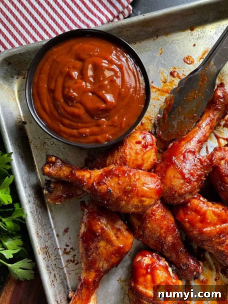 Smoky Bourbon Chipotle BBQ Sauce 7 BBQ chicken glistening with homemade bourbon chipotle sauce, served in a baking dish.