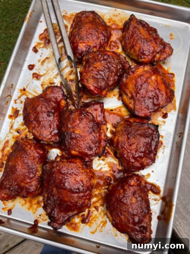 barbecued chicken recently pulled from the smoker on a baking sheet.
