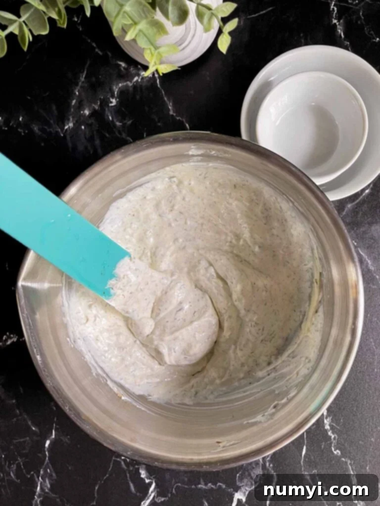chip dip ingredients combined in a metal bowl