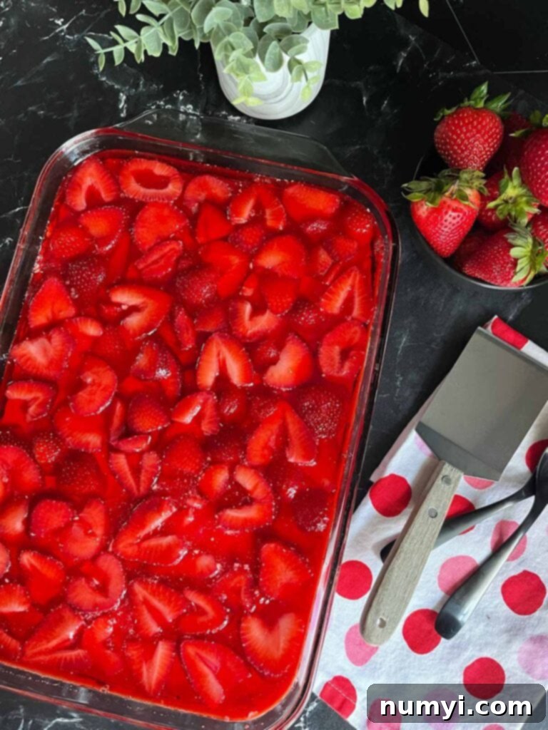 A dish full of strawberry pretzel salad.