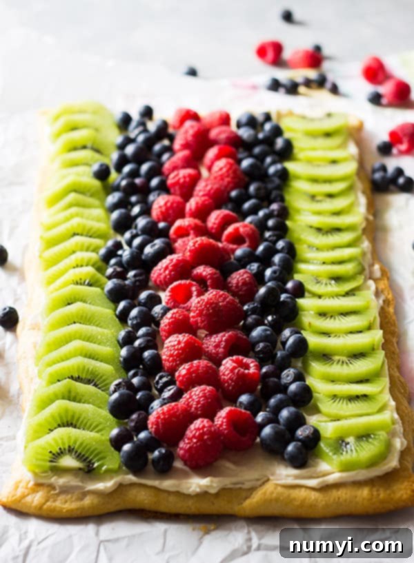 This Easy Fruit Pizza is an easy recipe thanks to store bought crescent dough. It's then topped with sweetened cream cheese and loads of juicy fruit!