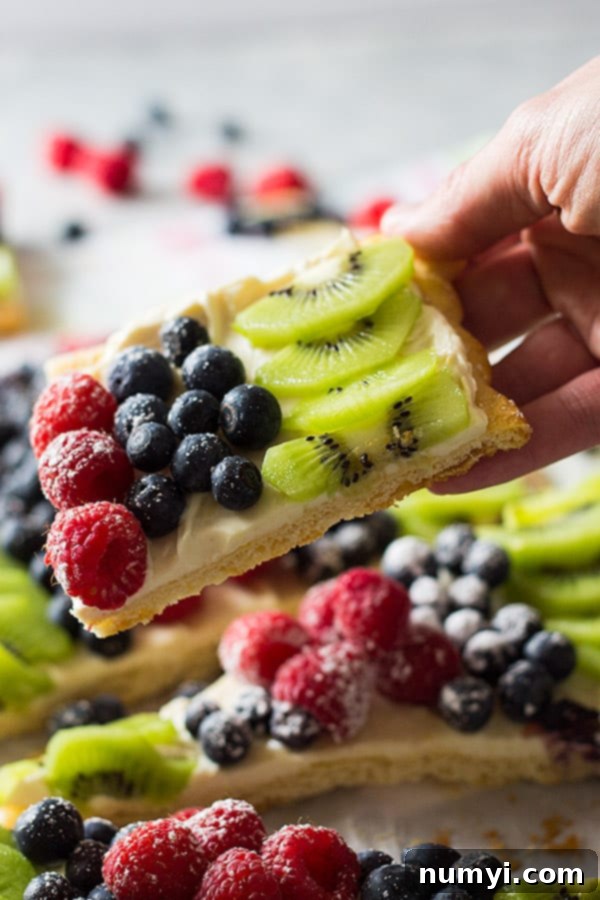 This Easy Fruit Pizza will make a great appetizer or quick dessert for any party you may have! It's topped with sweetened cream cheese and scrumptious fruit!