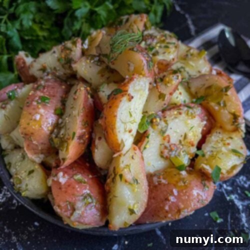 Delicious Herb Potato Salad (no mayo) on a plate, ready to serve.