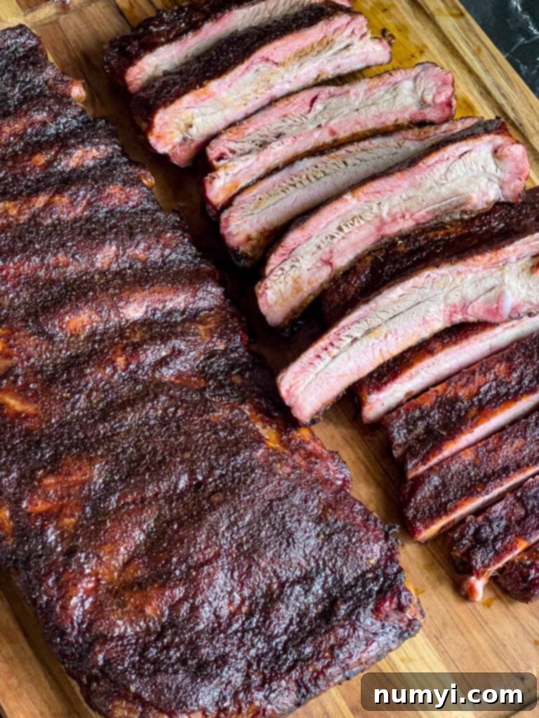 Two glorious racks of St. Louis style ribs on a cutting board, ready for a feast.