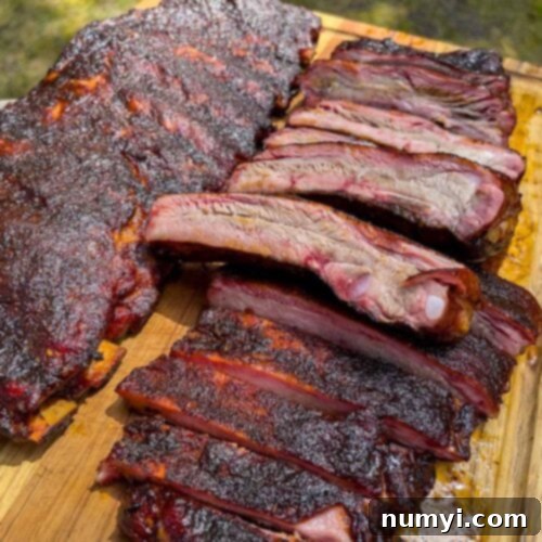 Two racks of St. Louis style ribs on a cutting board