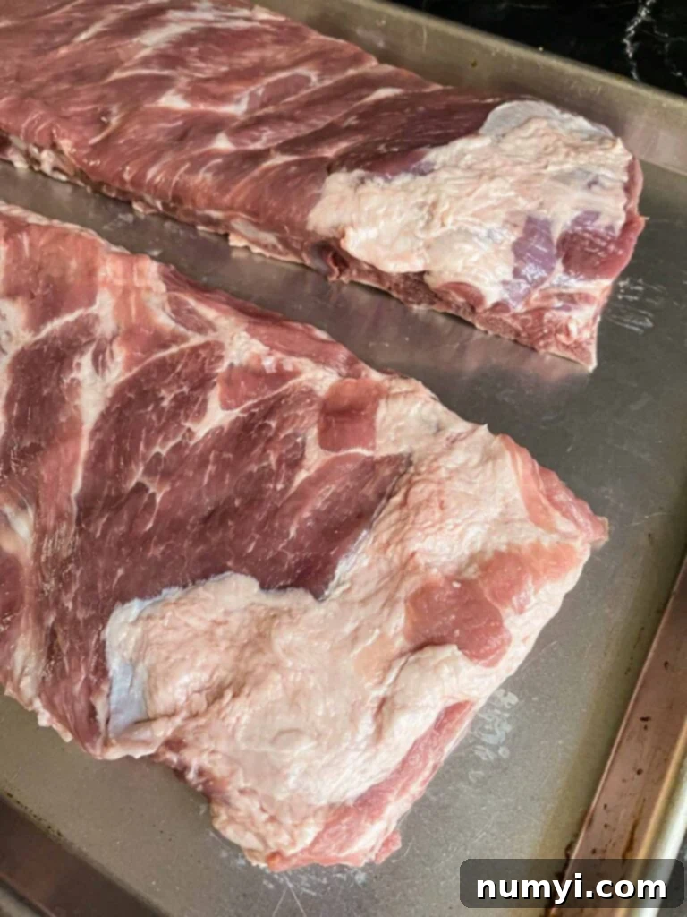 Ribs showing where the fat needs to be removed for better smoke and rub penetration.