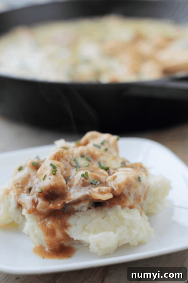 Chicken and Swiss Skillet served in a skillet, topped with melted cheese and ready to eat. A quick 30-minute meal for busy weeknights.