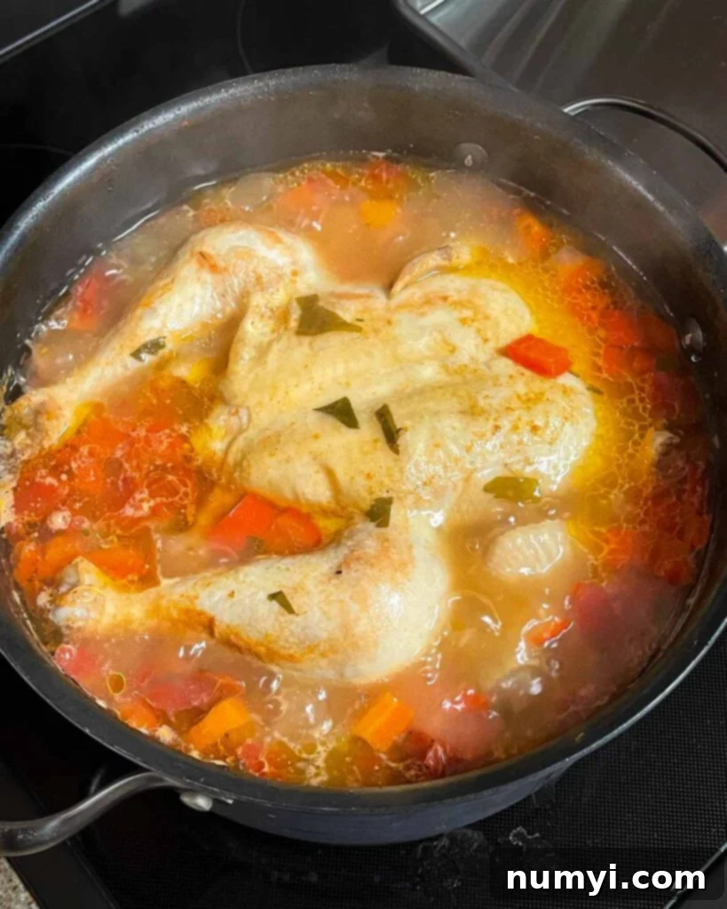 Simmering Sicilian chicken soup in a large stock pot.