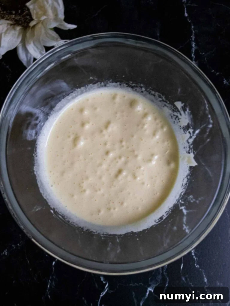 Cake batter in a glass mixing bowl, showcasing its smooth texture before baking.