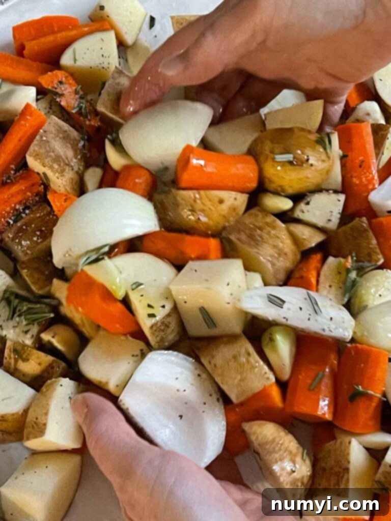 One-Pan Wonder: Roasted Chicken and Vegetables 5 Chicken thighs, potatoes, carrots, onions, and garlic tossed in seasonings and olive oil in a lined baking sheet.