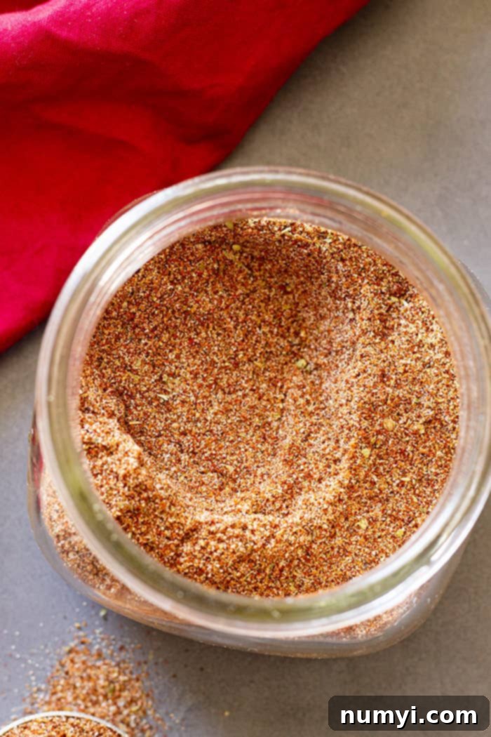 A charming glass jar filled with freshly made homemade taco seasoning, ready for storage.
