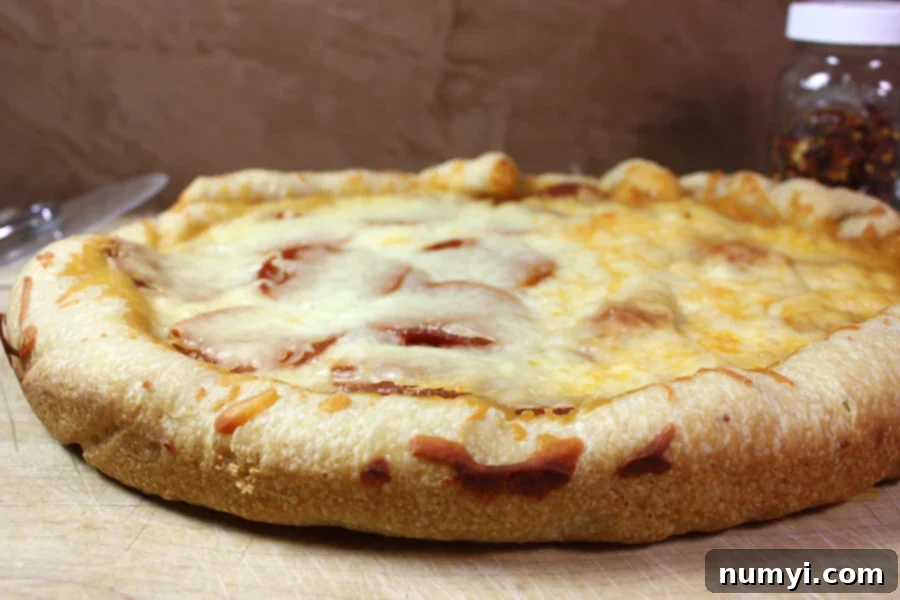 Slow cooker pizza resting on a cutting board, ready to be served.
