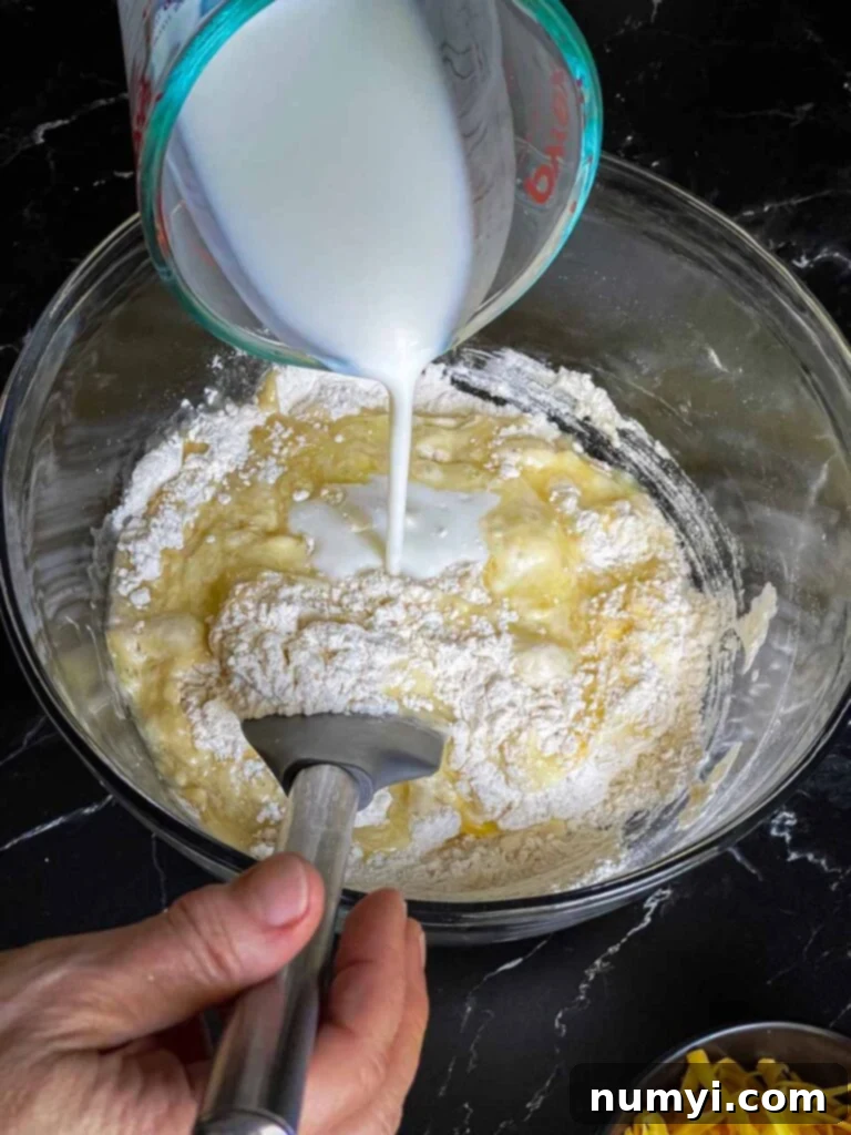 Buttermilk being stirred into the dry ingredients.