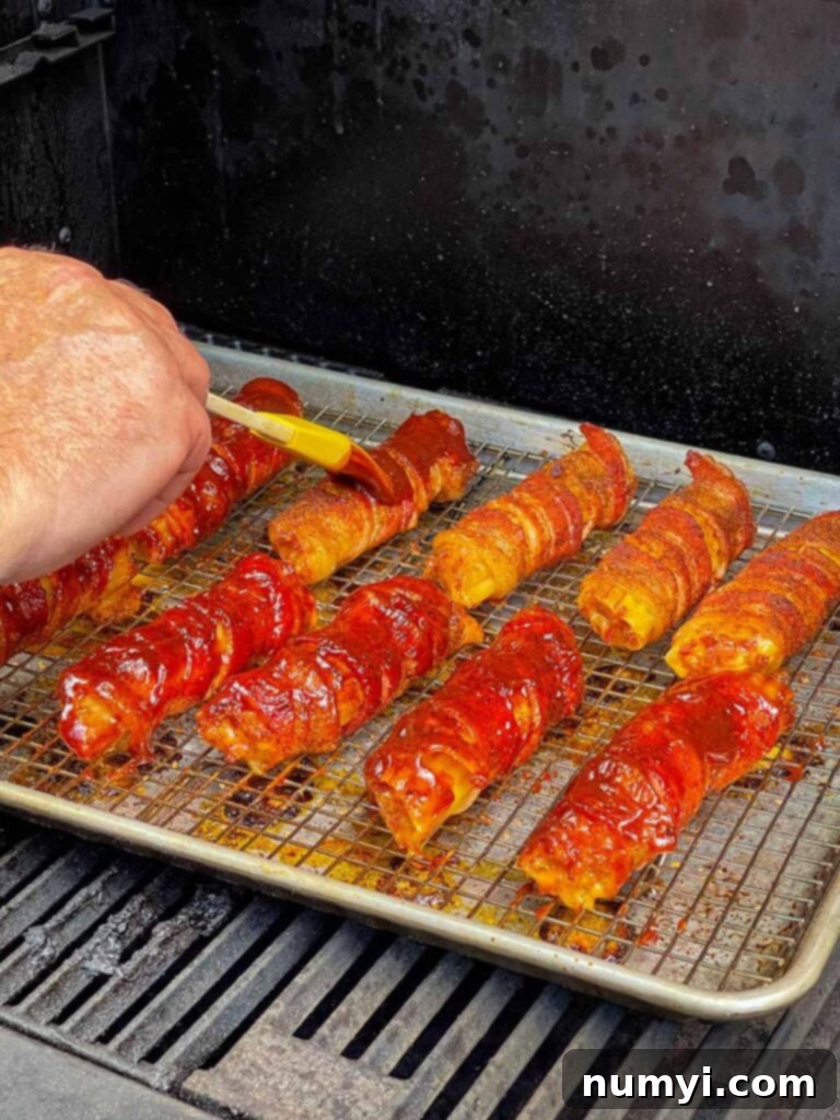 Applying barbecue sauce to the smoked shotgun shells.