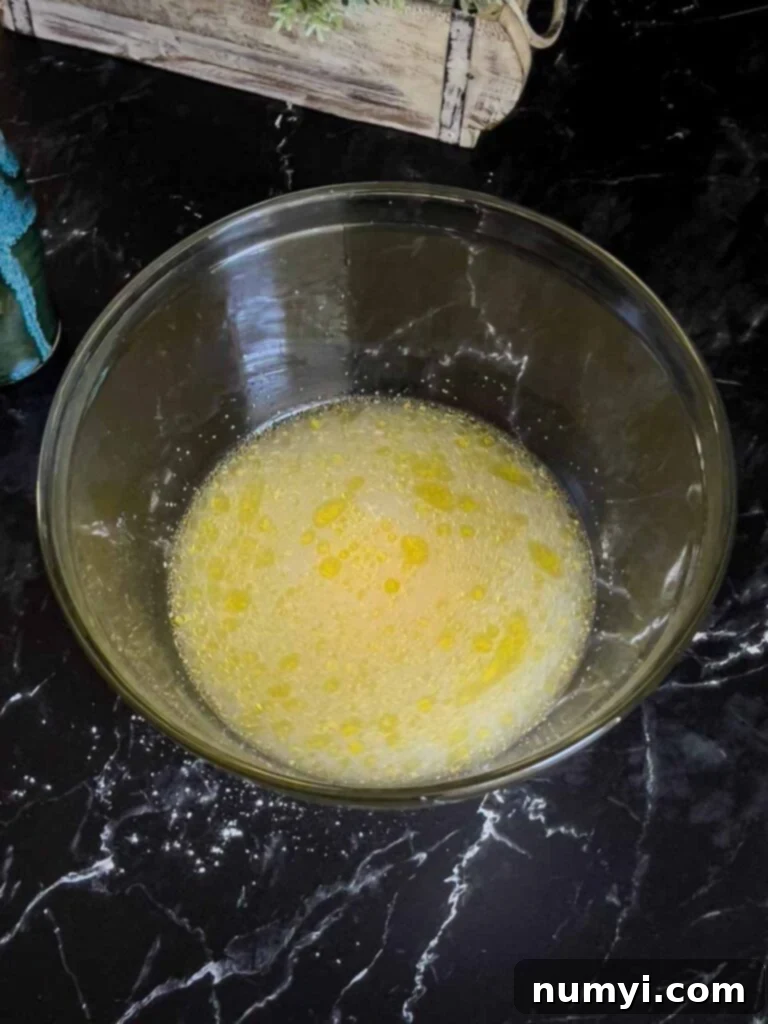 The wet ingredients for the focaccia mixed together in a glass bowl.