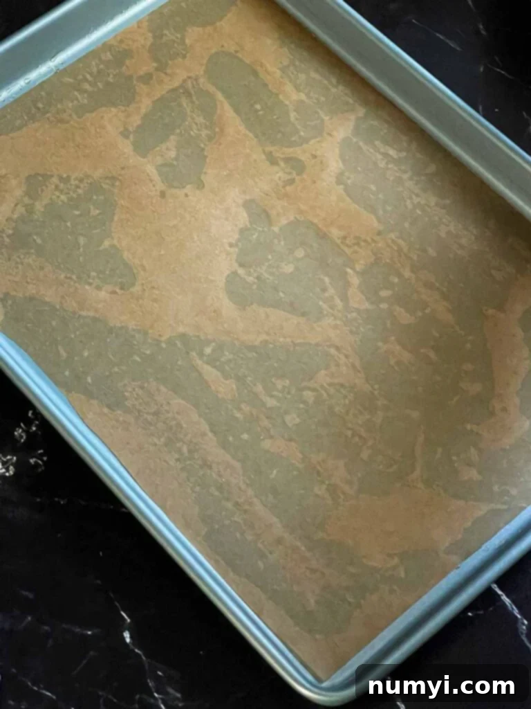 A sheet of parchment paper on an oil lined baking sheet.