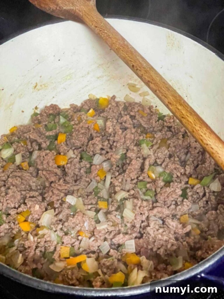 Grandma's American Goulash 6 Browned ground beef with other spices in a large dutch oven.