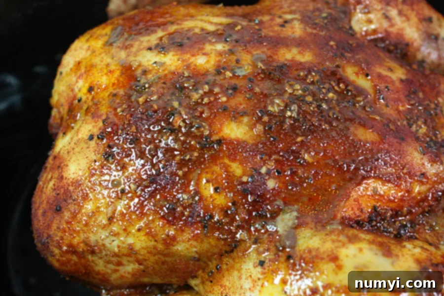 Perfectly Tender Slow Cooker Roasted Chicken 2 A perfectly roasted whole chicken simmering in a slow cooker, ready to be served.