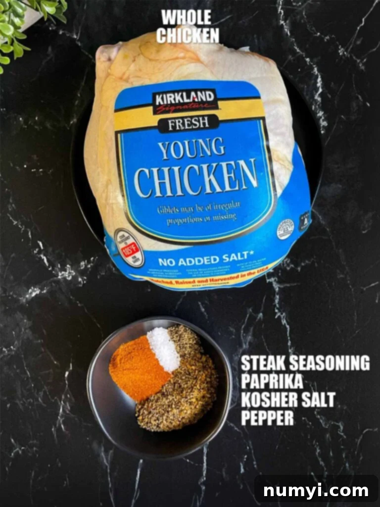 Perfectly Tender Slow Cooker Roasted Chicken 3 Raw whole chicken and a ramekin of seasoning blend on a dark preparation surface, showcasing ingredients needed for the recipe.