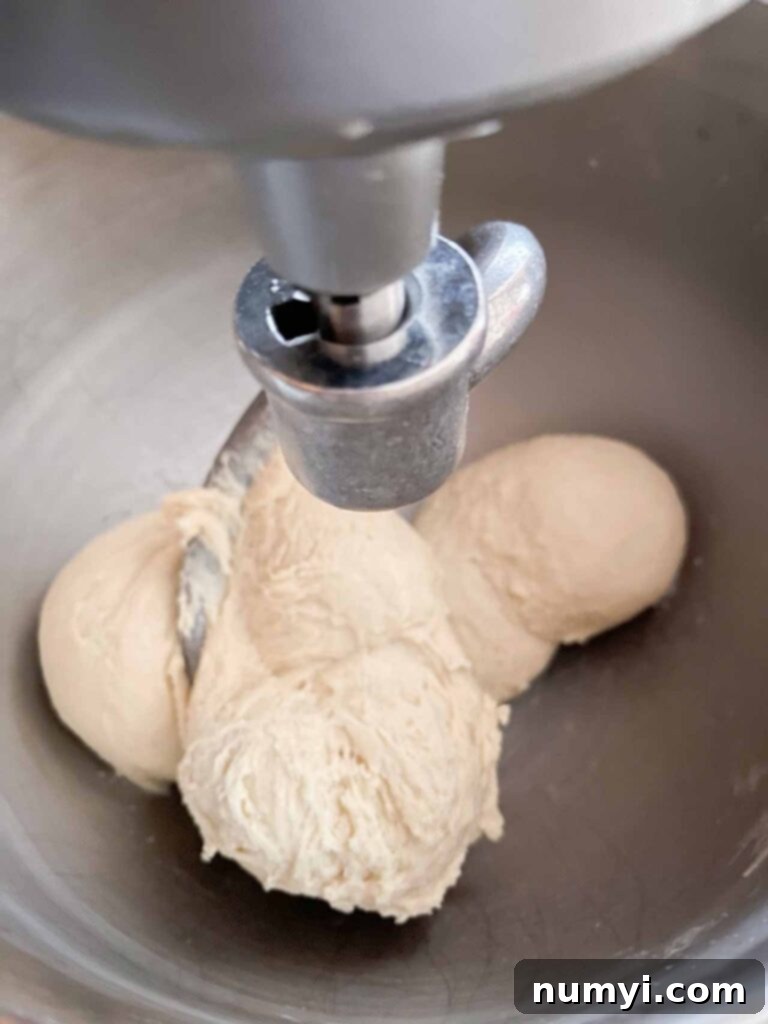 The crescent roll dough mixing in a metal bowl, showcasing its smooth texture.