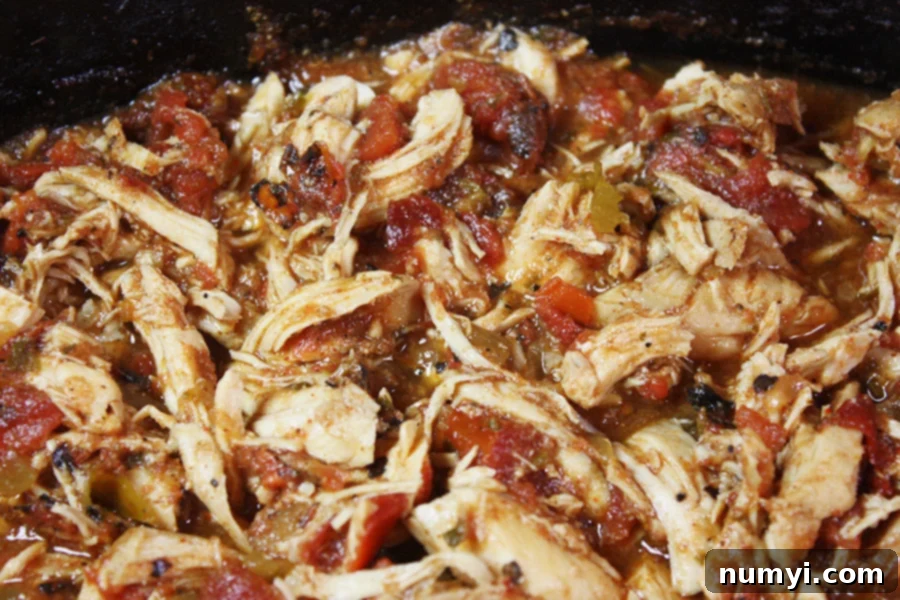 Shredded Slow Cooker Mexican Chicken still in the crock of the slow cooker, ready to be served.