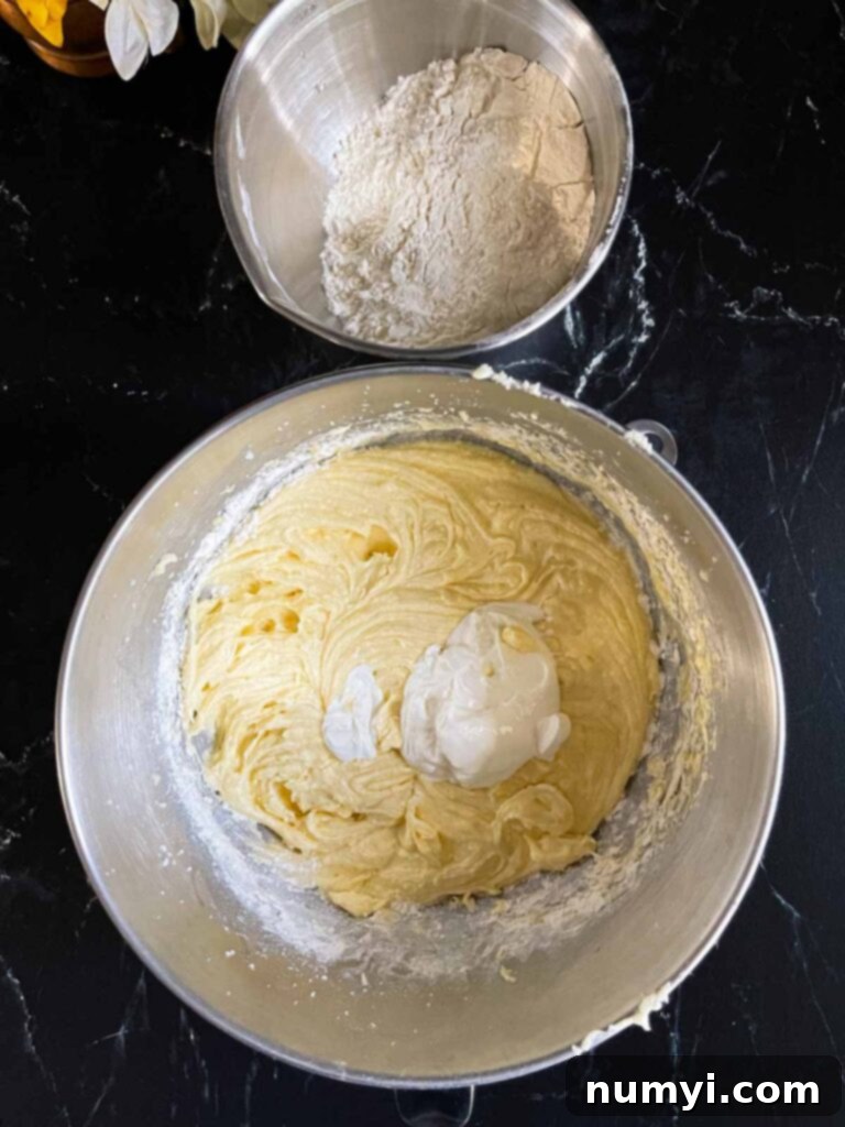Ingredients for old fashioned sour cream pound cake in mixing bowls.