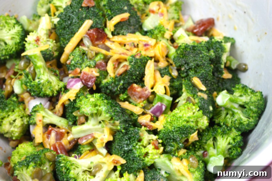 Broccoli salad in a white bowl.