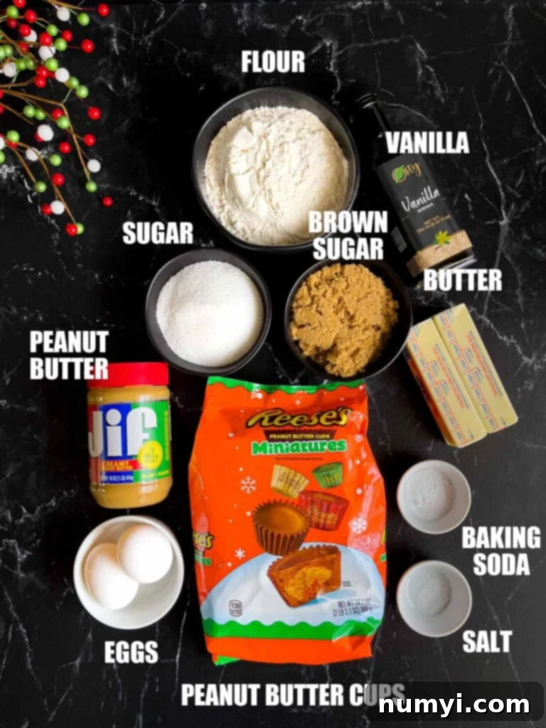 Chocolate Peanut Butter Cup Cookies 3 Various peanut butter cup cookie ingredients laid out on a dark kitchen counter: butter, peanut butter, sugars, flour, eggs, vanilla, and miniature Reese's.