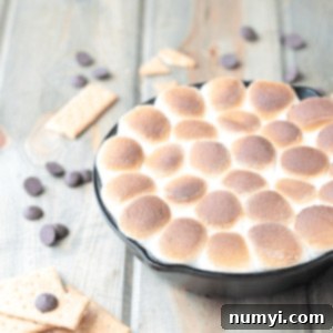 With this Caramel S'mores Dip you won't be missing the campfire!! Oooey and goooey toasted marshmallow with smooth caramel and chocolate, what's not to love?? | Countryside Cravings