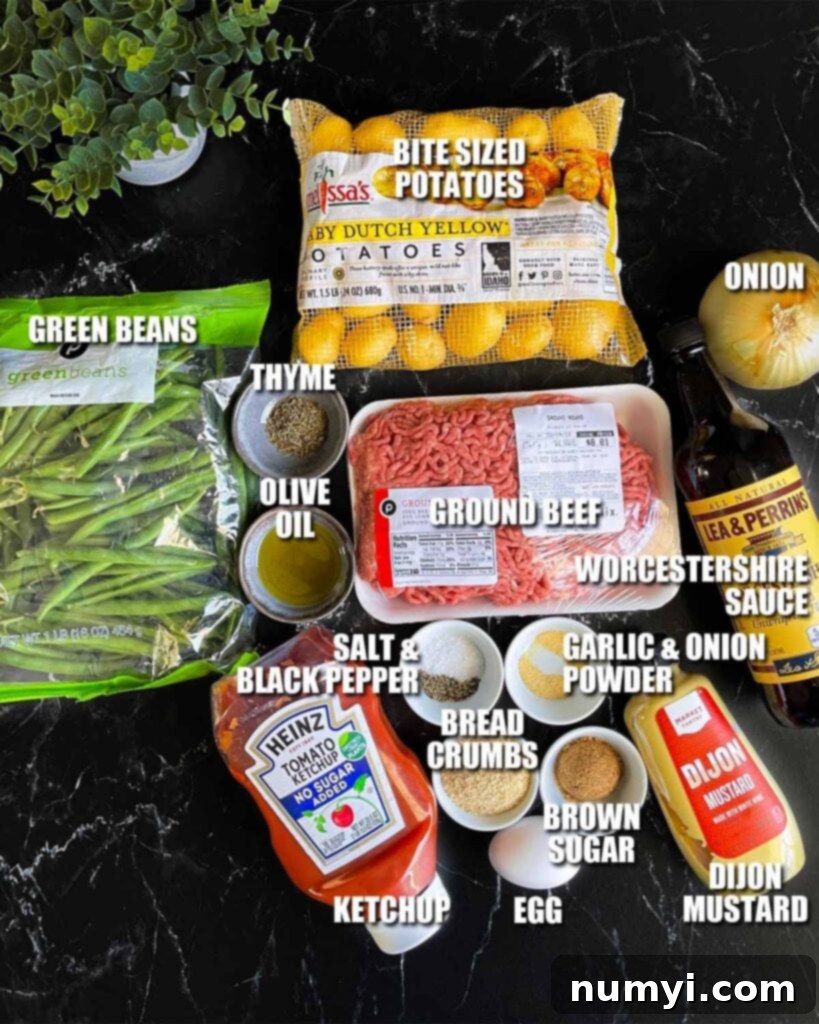 Ingredients for mini meatloaves on a dark surface.