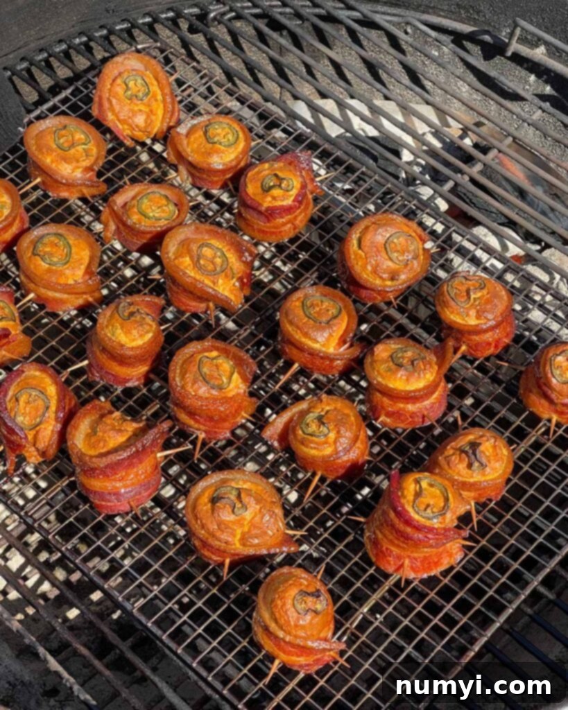 Smoked Bacon Sausage Bites 13 Perfectly smoked pig shots with crispy bacon and golden-brown cheese filling, ready to be removed from the smoker.