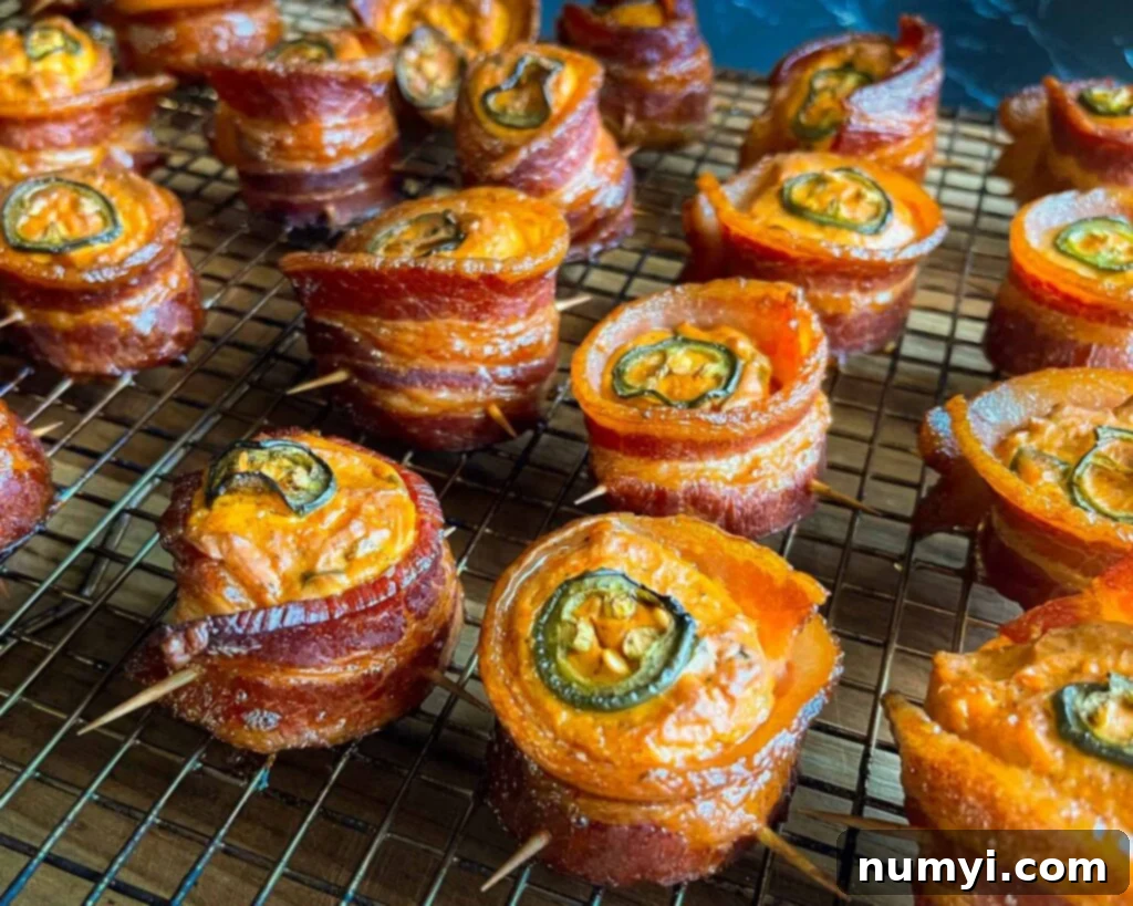 Smoked Bacon Sausage Bites 14 Close-up of freshly smoked pig shots arranged on a wire cooling rack, highlighting the crispy bacon and melted cheese.