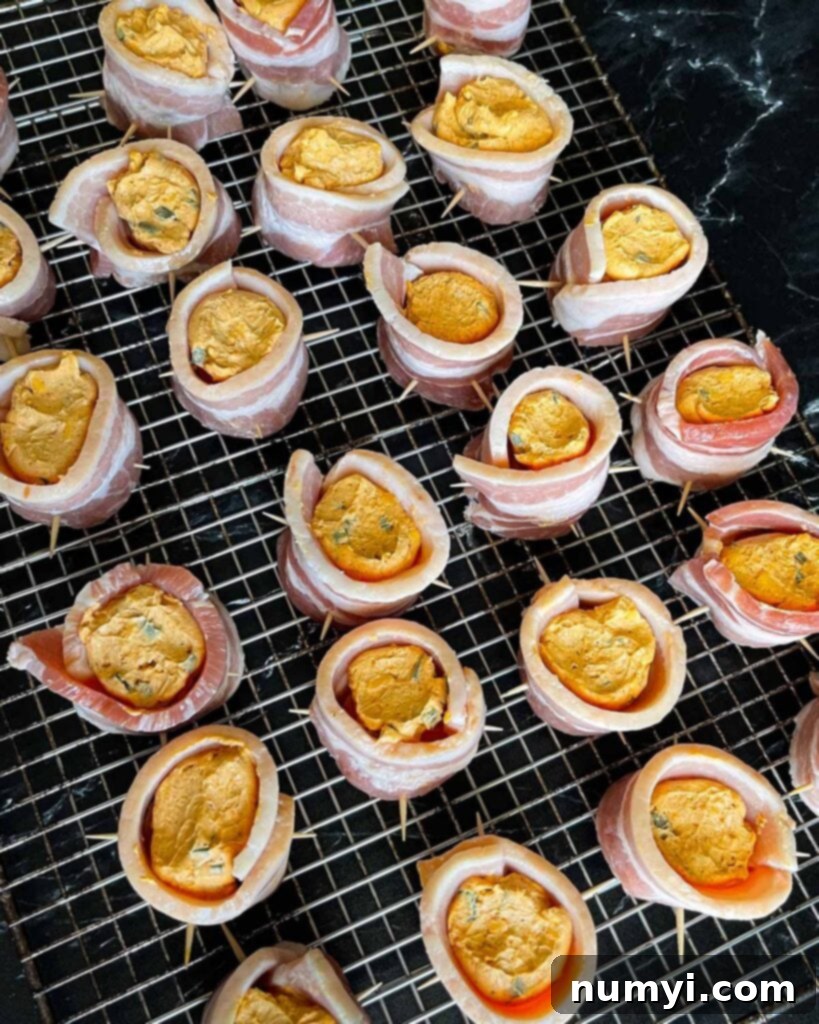 Smoked Bacon Sausage Bites 10 Smoked pig shots filled with cheesy jalapeño mixture, arranged on a cooling rack, ready for the smoker.