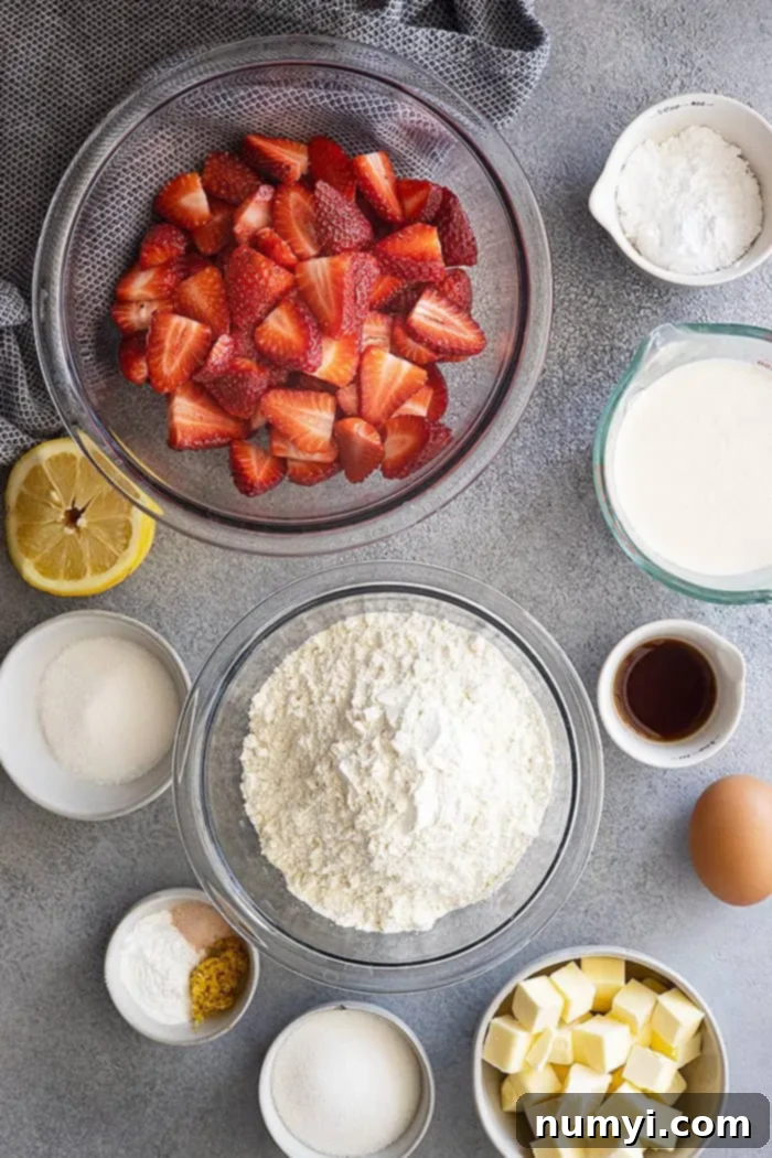 Carefully arranged ingredients for homemade strawberry shortcake, including fresh strawberries, flour, butter, and cream, ready for preparation.