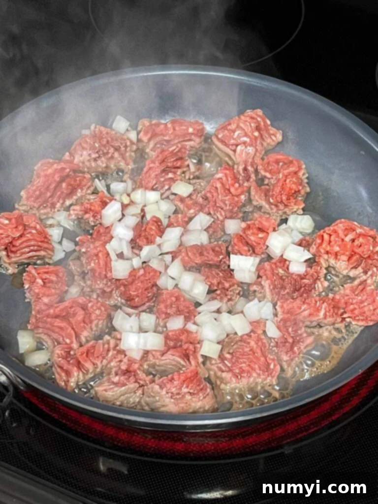 The Ultimate Chile Relleno Casserole 6 Ground beef with onions browning in a skillet.