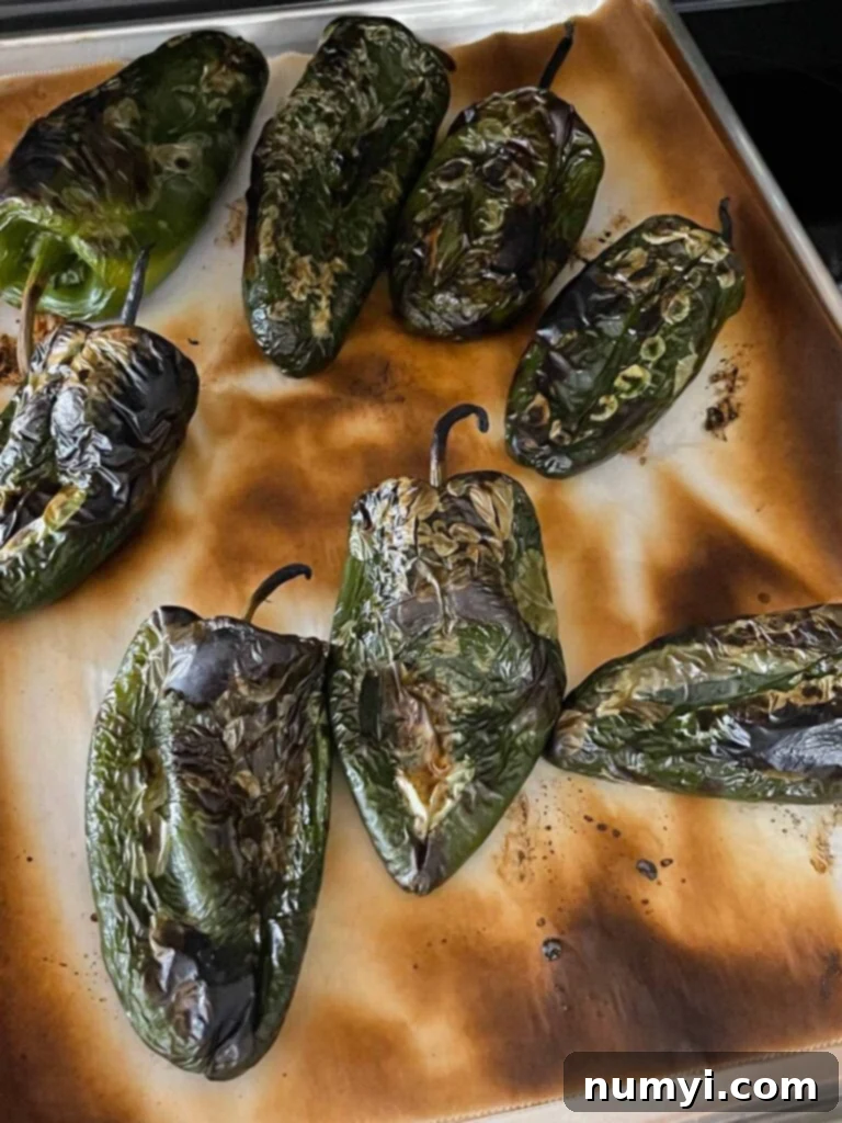 The Ultimate Chile Relleno Casserole 7 Roasted poblano peppers on a baking sheet.
