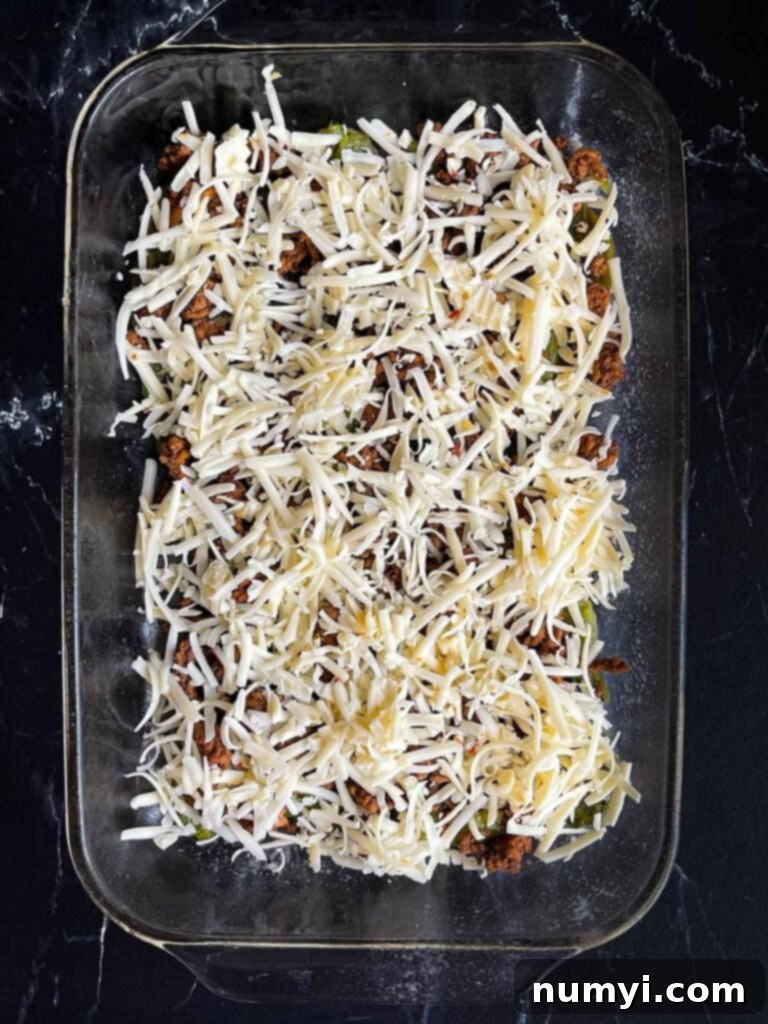 The Ultimate Chile Relleno Casserole 10 One layer of chile relleno casserole in glass baking dish.