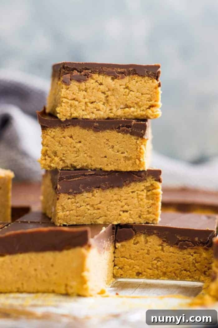 No bake chocolate peanut butter bars stacked on top of each other in a tall tower.