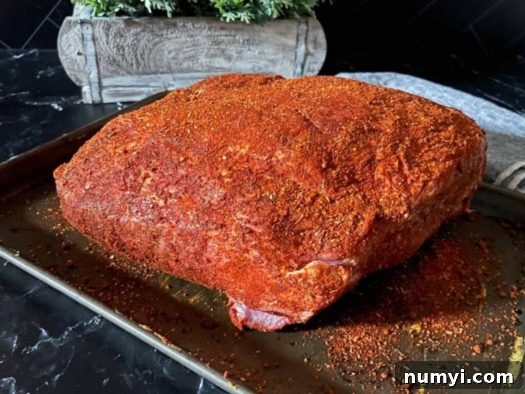 A pork butt with a memphis style rub applied. 