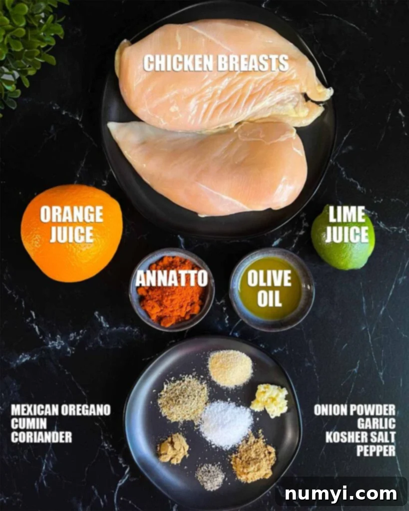 Fresh ingredients laid out for Pechuga Asada marinade: annatto, citrus, and various spices on a dark background.