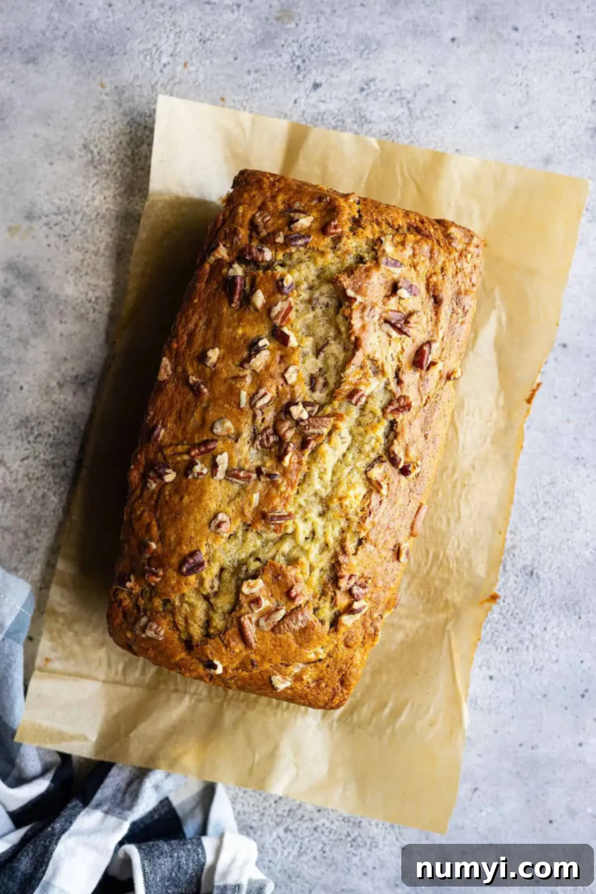 Ultimate Banana Nut Loaf 7 Overhead view of banana nut bread fresh from the oven. Can see the nuts sprinkled on top.