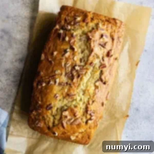 Ultimate Banana Nut Loaf 8 Overhead view of banana nut bread fresh from the oven. Can see the nuts sprinkled on top.