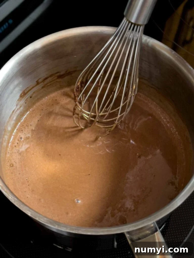 The Easiest Mississippi Mud Cake 11 Chocolate frosting for the Mississippi Mud Cake in a metal sauce pan.