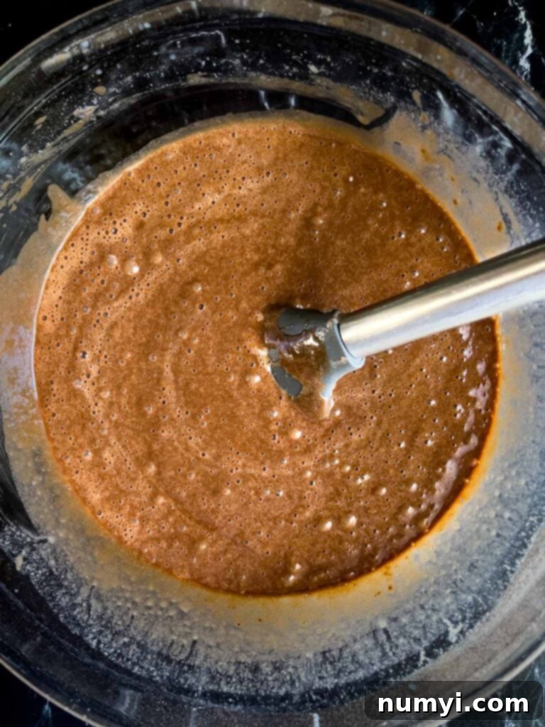 The Easiest Mississippi Mud Cake 9 Mississippi Mud Cake batter mixed together in a glass mixing bowl.