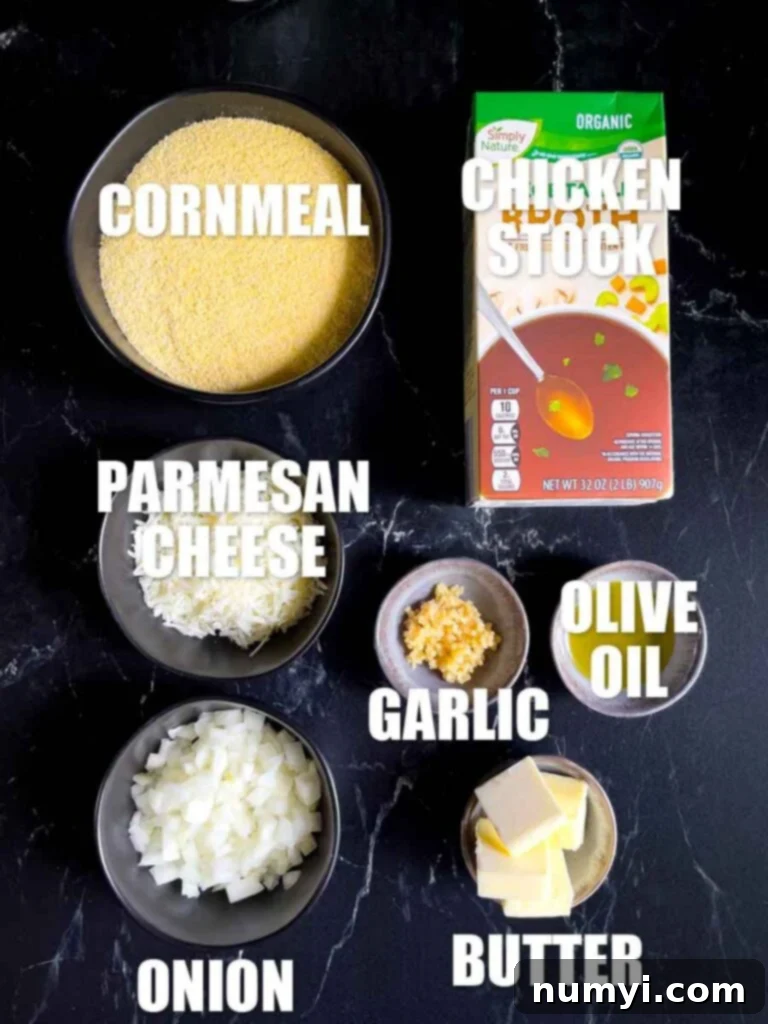 Ingredients for a basic polenta laid out on a black marble countertop.