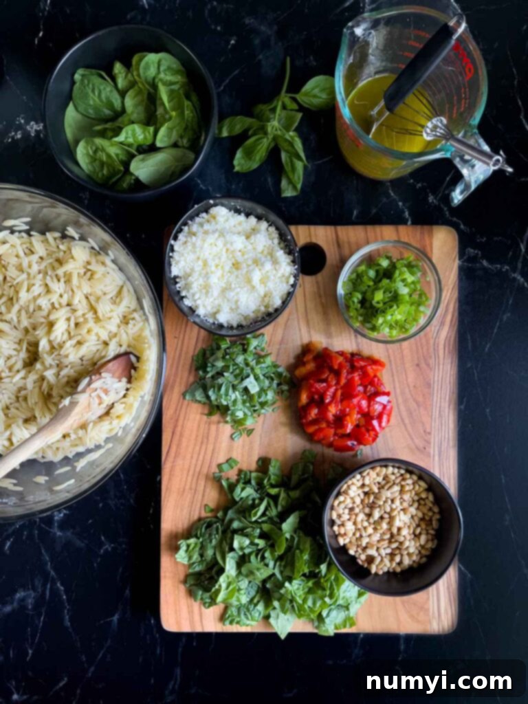 Add-ins for the spinach and feta orzo salad on a dark surface.
