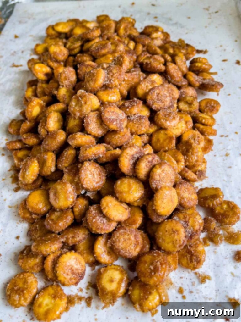Oyster cracker churro snack mix broken up on a baking sheet.
