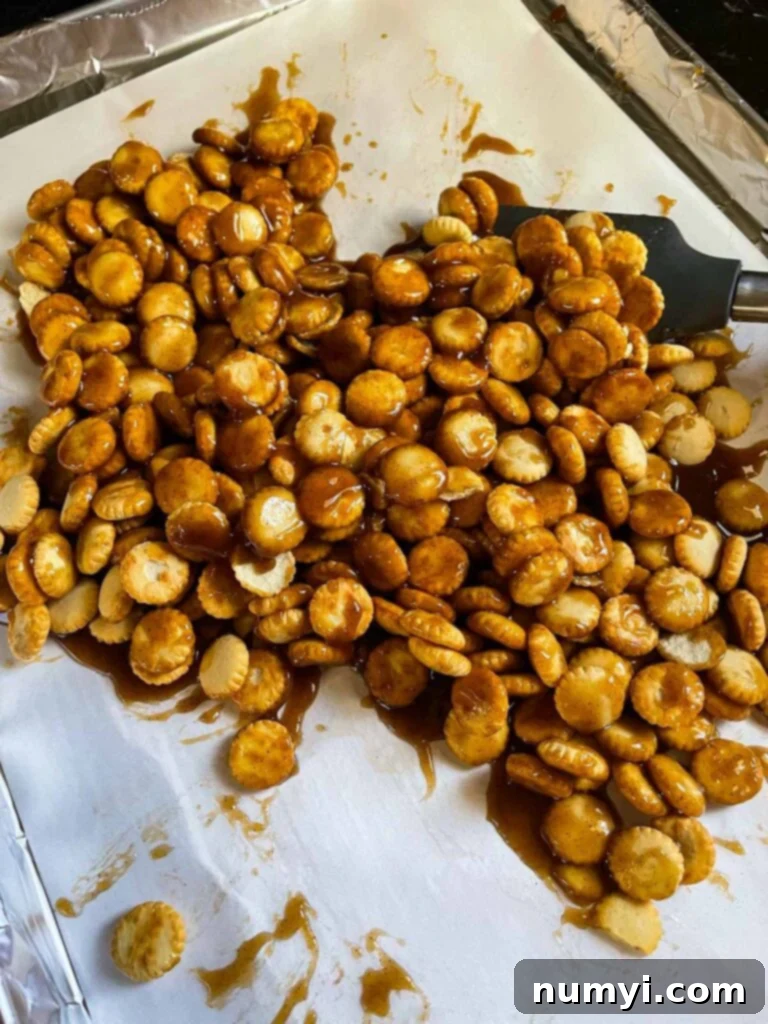 Toffee mixture on oyster crackers on a baking sheet.