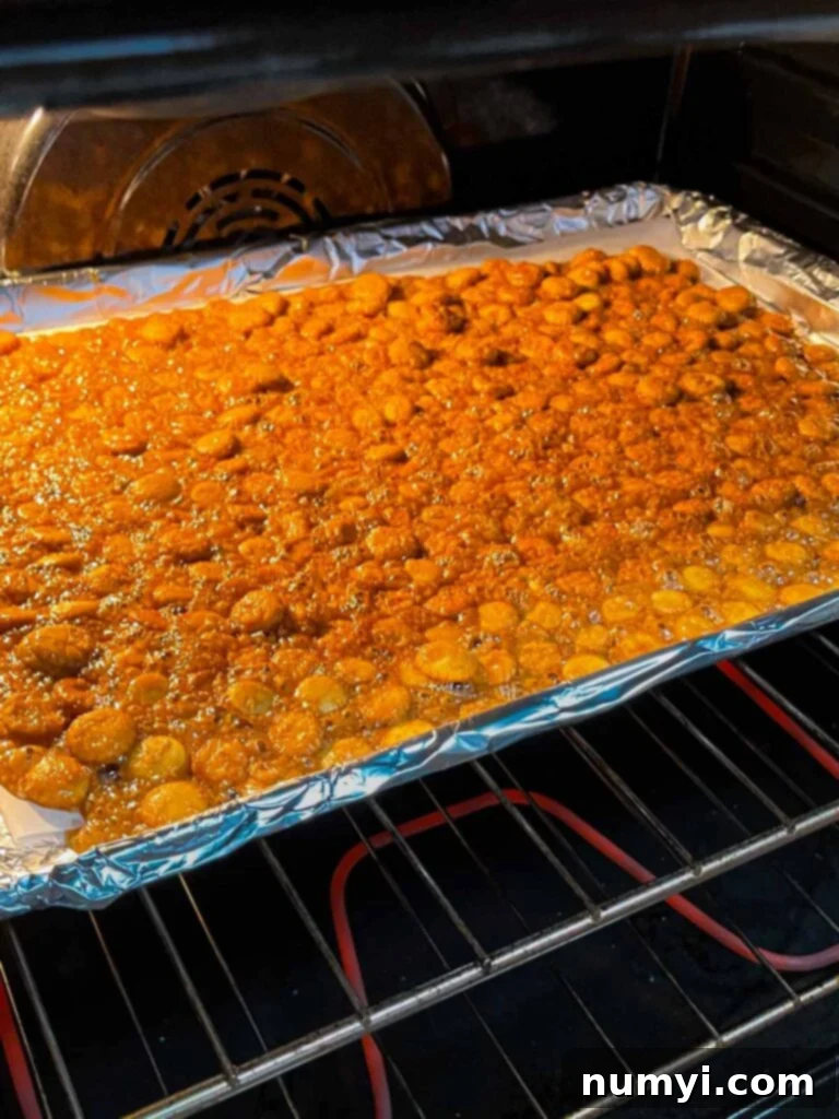 The oyster cracker churro snack mix baking in the oven.